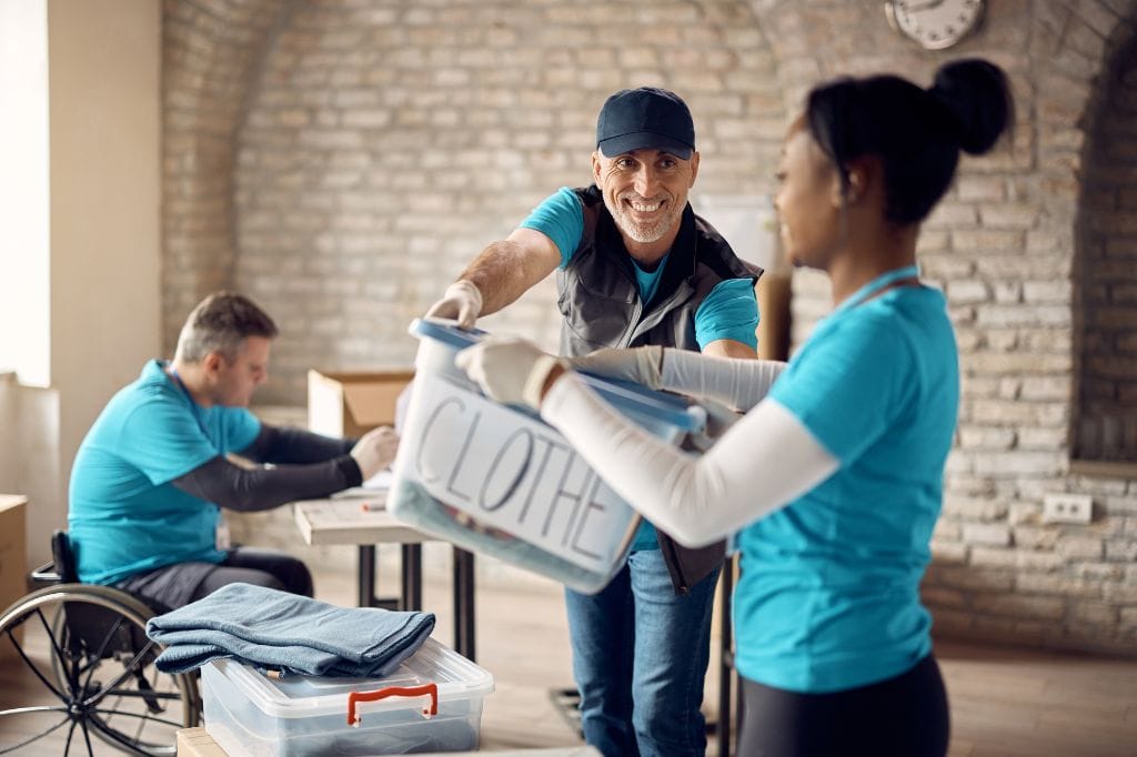 Team sorting clothes into boxes
